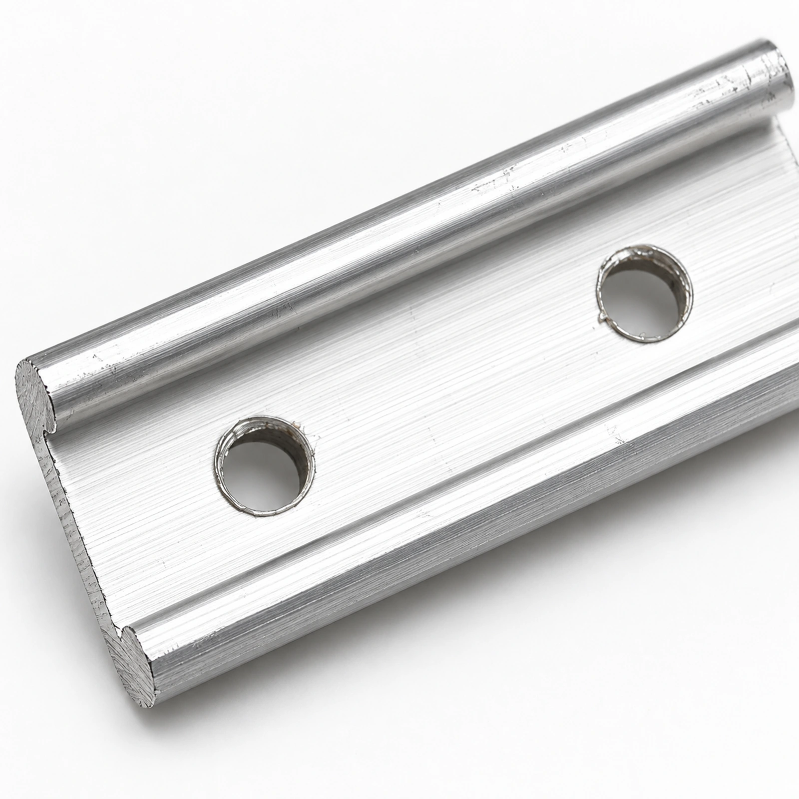 Close-up of two holes and rolled edges on a connecting strip