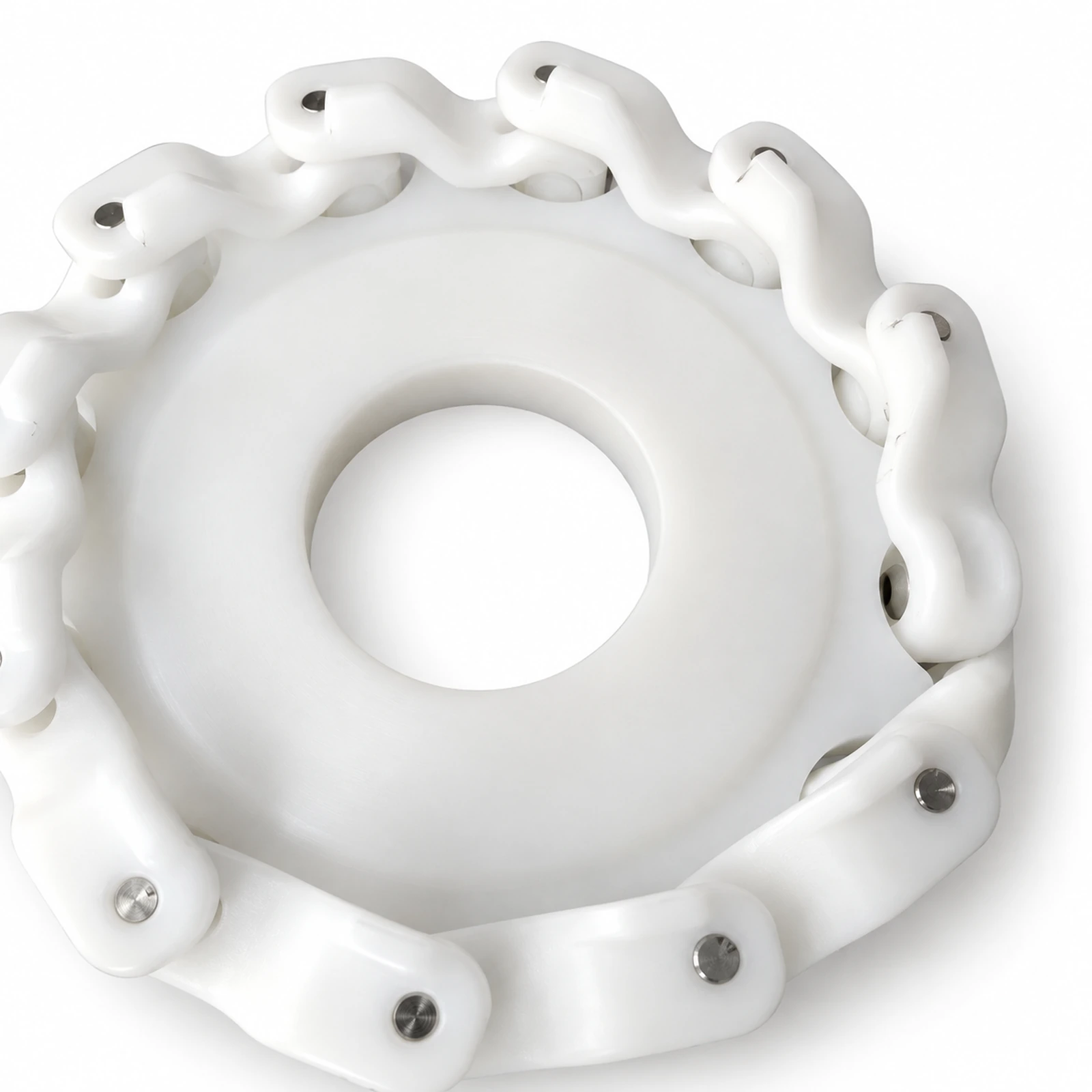 Close-up of a white conveyor sprocket engaging a white conveyor chain