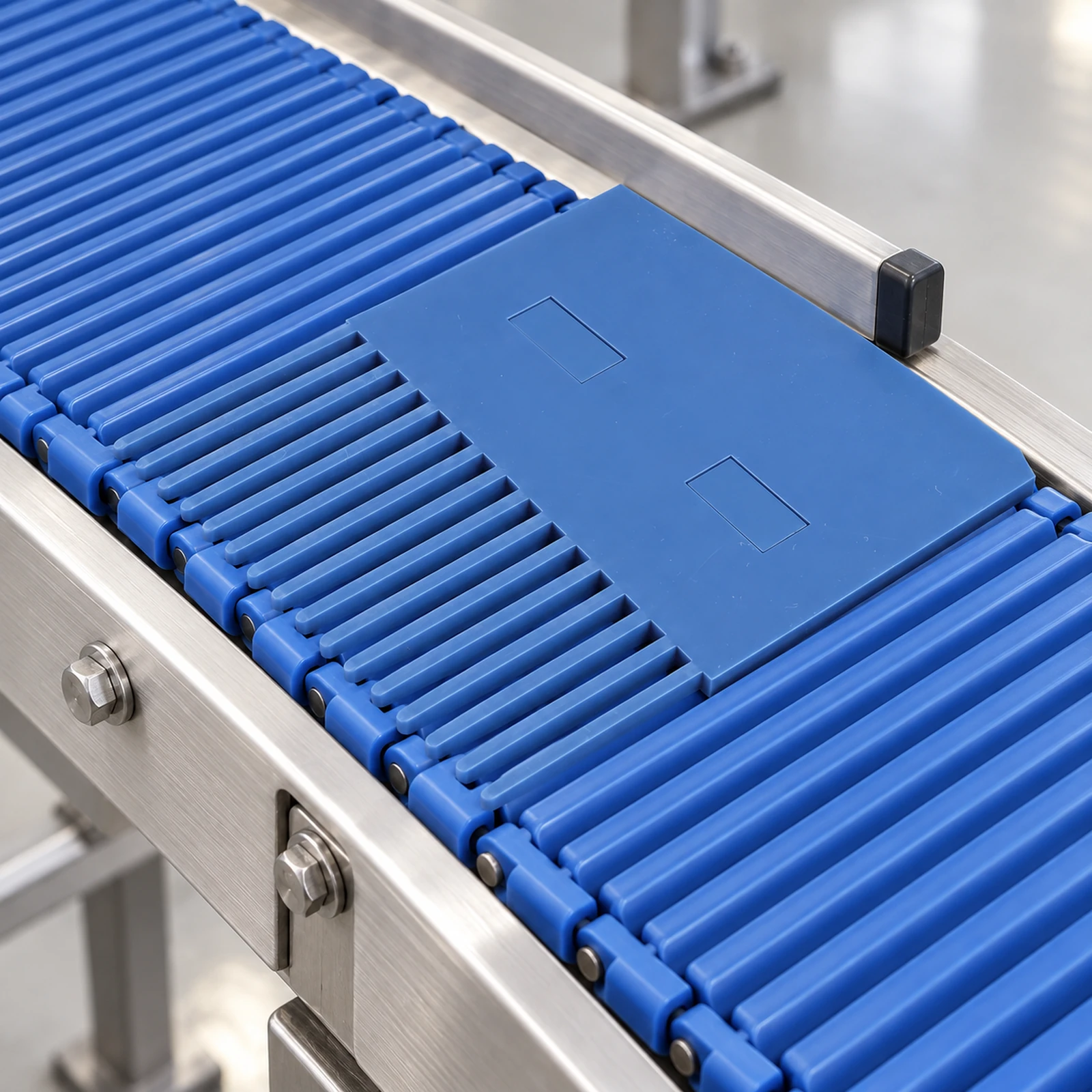 Blue transfer plate and rollers between conveyor sections