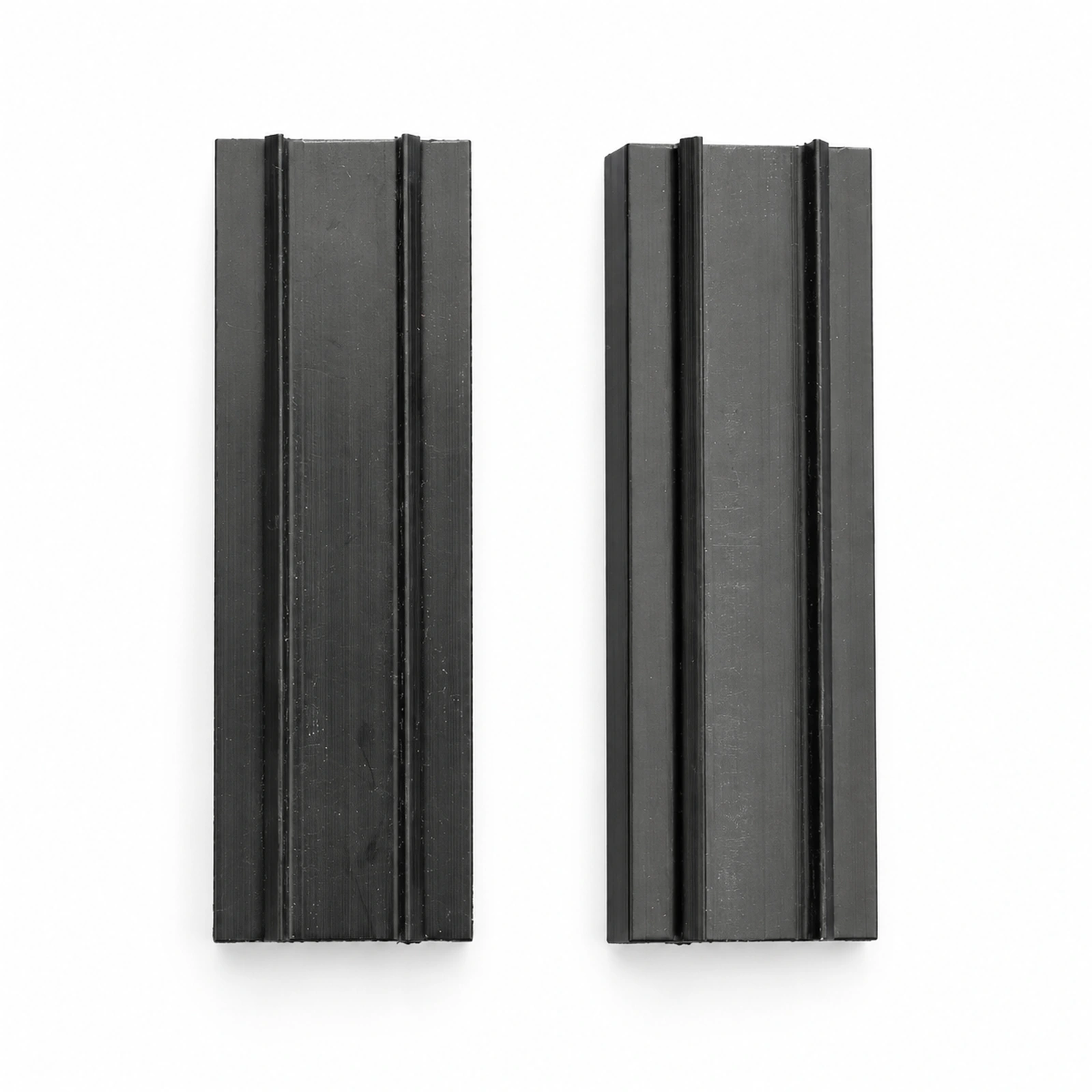 Close view of two black conveyor wear strip profiles