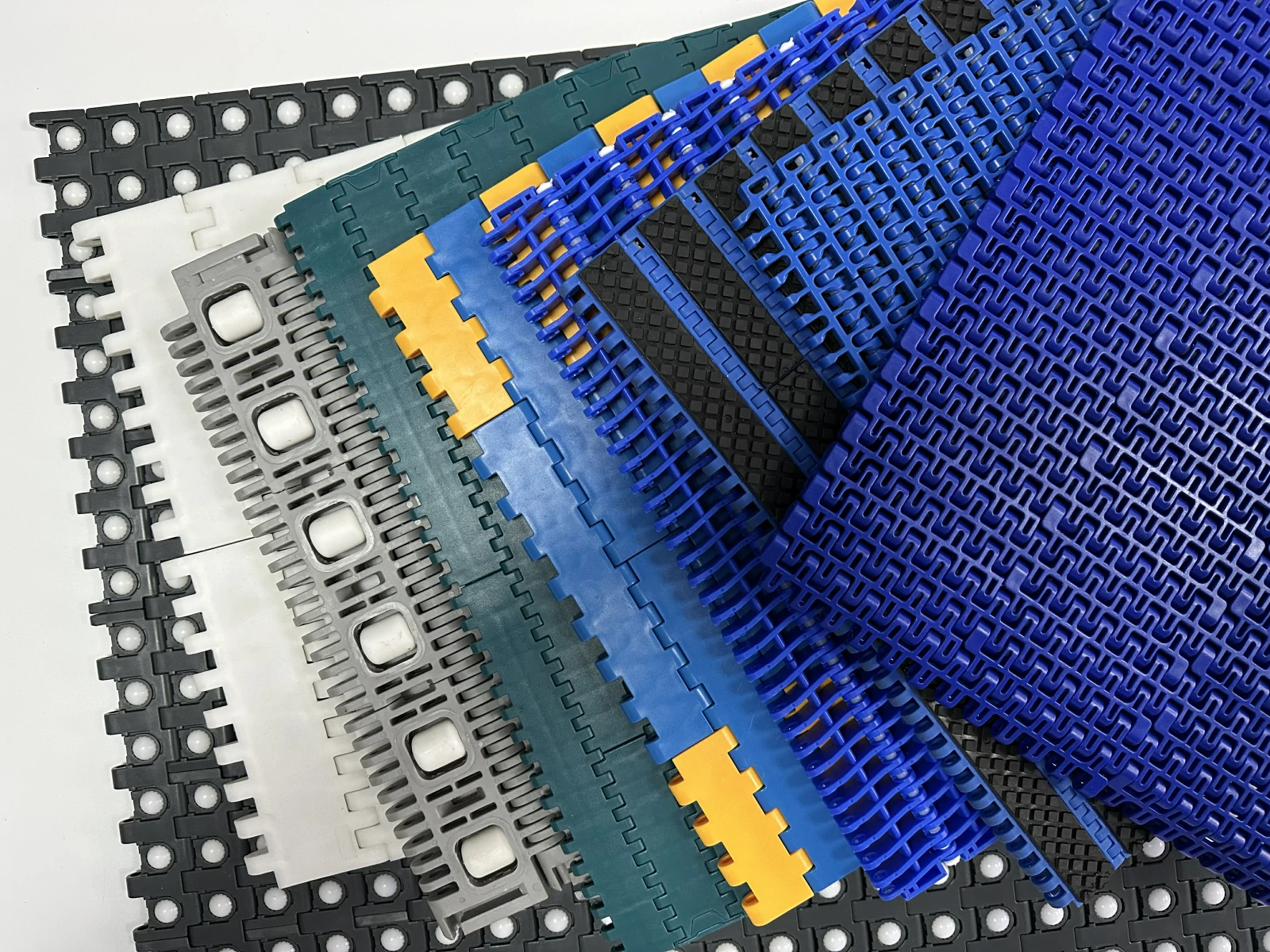 Assorted plastic modular belt surfaces in several link patterns