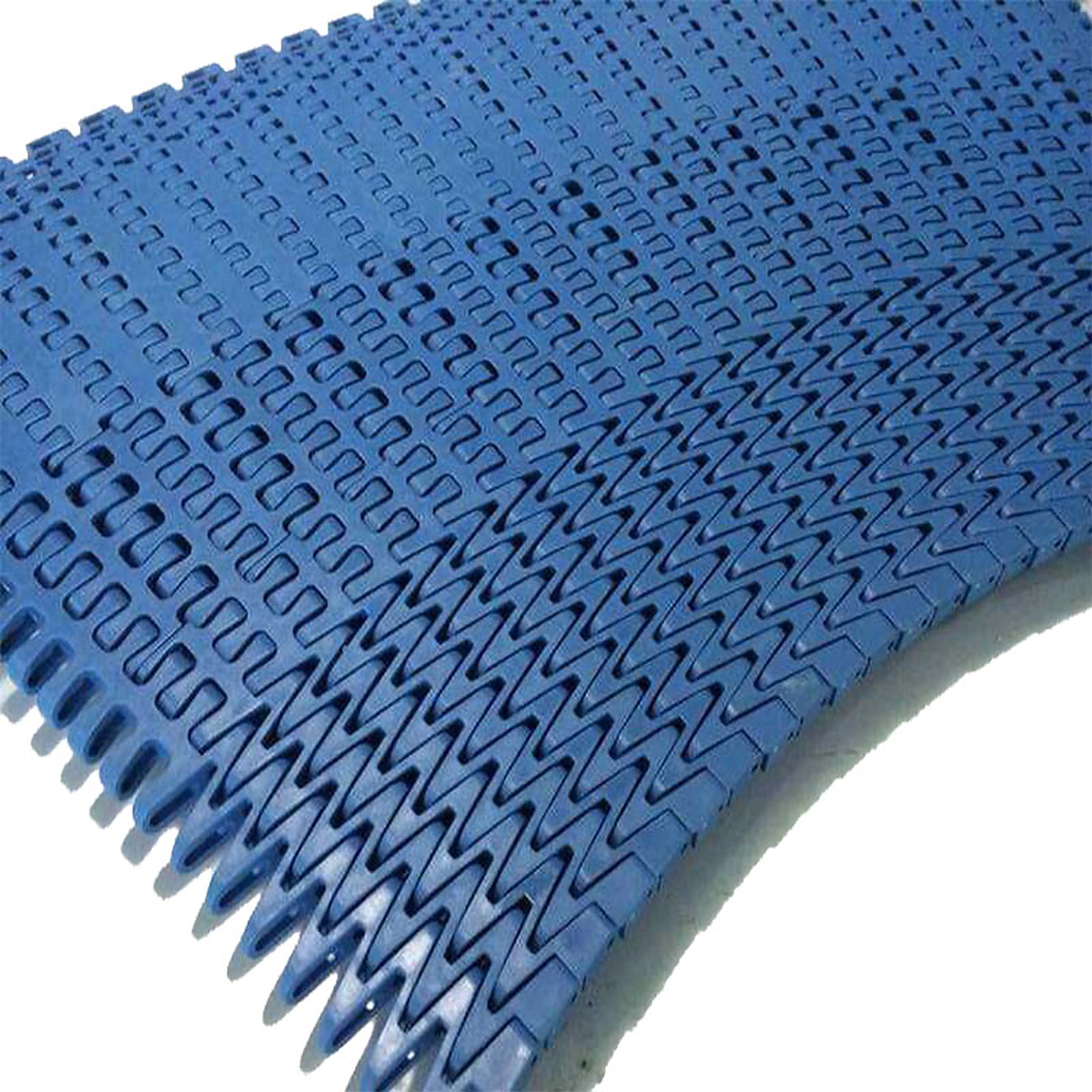Close-up of curved modular belt link pattern